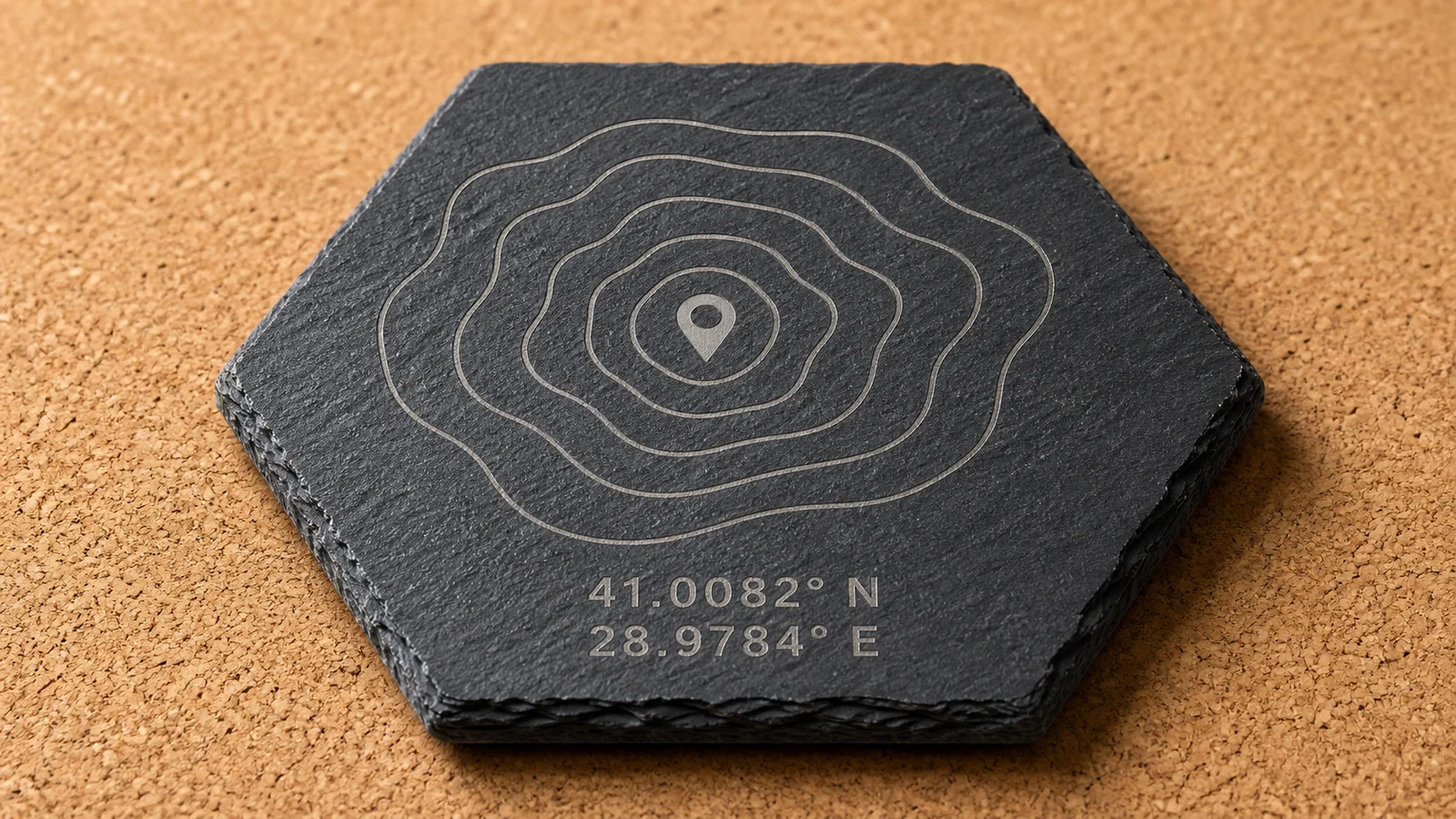 Topographic contours and coordinates laser engraved on a hexagonal slate coaster